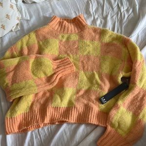 Brand new orange and yellow checkered sweater